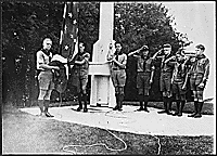 H0024-2. Gerald R. Ford, Jr. holds the flag as he and his fellow members of the Eagle Scout Guard of Honor prepare to raise the colors over Fort Michilimackinac at Mackinac Island State Park, MI. The troop served as guides during the summer months. August 1929.