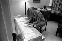 President Ford examines documents related to potential Vice Presidential nominees in the office of his Counsellor, Robert T. Hartmann. August 15, 1974.