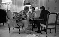 President Ford, in his pajamas, meets with staff members Steve Todd (military aide) and Terry O'Donnell in the President's suite in the Akasaka Palace, Tokyo, Japan.