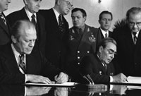 President Ford and Soviet General Secretary Leonid I. Brezhnev sign a joint communiqué following talks on the limitation of strategic offensive arms. The document was signed in the conference hall of the Okeansky Sanatorium, Vladivostok, USSR. November 24, 1974