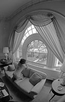 First Lady Betty Ford gazes toward the Oval Office from a window in the White House residence.  