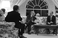 President Ford discusses the evacuation of Saigon with Secretary of State Henry Kissinger and his Deputy Assistant for National Security Affairs Brent Scowcroft during a late night meeting in the White House residence. April 28, 1975. 