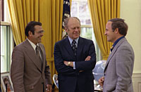 President Ford chats with Chief of Staff Donald Rumsfeld and Rumsfeld’s assistant Richard Cheney in the Oval Office