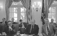 President Ford, Secretary of State Henry A. Kissinger (left) and Secretary of Defense James R. Schlesinger (right) at a meeting with bipartisan congressional leaders to discuss the situation in South Vietnam.  Cabinet Room.  April 29, 1975. 