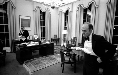 Departing early from a White House dinner in honor of Netherlands’ Prime Minister, Johannes den Uyl, Secretary of State Henry A. Kissinger and Deputy Assistant for National Security Affairs Lt. Gen. Brent Scowcroft work into the night to monitor developments in the retaking of the S.S. Mayaguez. 