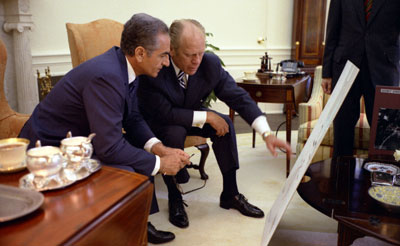 President Ford and the Shah of Iran, Mohammad Reza Pahlavi, look at charts related to the USS Mayaguez military operation earlier that month, during the State Visit of the Shah and Shahbanou, Farah Pahlavi.  May 15, 1975.  