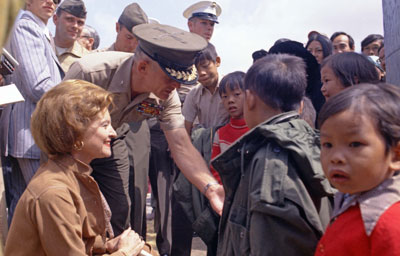 First Lady Betty Ford greets newly-arrived Vietnamese children at the Camp Pendleton Refugee Camp in California.  May 21, 1975.  