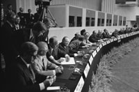 President Ford signs the Final Act of the Conference on Security and Cooperation in Europe as it is passed among European leaders for signature.  Finlandia Hall, Helsinki, Finland.  August 1, 1975.  