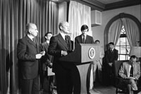 President Ford makes remarks to the press announcing the national Swine Flu Immunization Program.  Also shown are Center for Disease Control (CDC) Director David J. Sencer (to Ford’s left) and Secretary of Health, Education and Welfare F. David Mathews (to Ford’s right). 