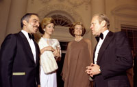 President and Mrs. Ford say goodnight to King Hussein and Princess Alia of Jordon as they depart the White House after a state dinner in their honor.  March 30, 1976. 