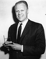 Representative Gerald R. Ford, Jr., poses with his Sports Illustrated Silver Anniversary Award