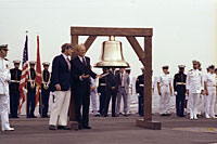 President Ford initiates the ringing of Bicentennial bells across the nation while on the flight deck of the USS Forrestal with Bicentennial Administration head John Warner in observance of Operation Sail activities in New York Harbor.