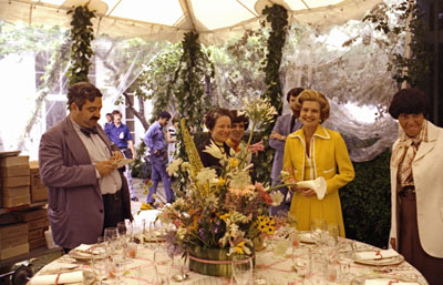 First Lady Betty Ford observes the table settings and staff preparations for the evening's state dinner in honor of Queen Elizabeth II of England and Prince Philip.