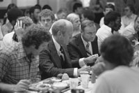 President Ford, University of Michigan football coach Bo Schembechler and members of the Michigan football team at the team’s training table during a visit to the campus to Kick-Off the President’s 1976 Presidential Campaign.  September 15, 1976.