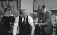 President Ford receives a swine flu inoculation from his White House physician, Dr. William Lukash.  