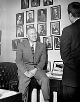 Representative Gerald R. Ford, Jr., talks to an unidentified visitor in his House Office