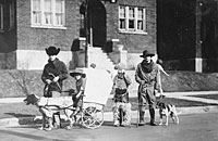 Gerald R. Ford, Jr., Carl Engel, Tom Ford, and an unidentified boy pose with their pioneer wagon after winning first prize in the Boys Day Parade. 1923.