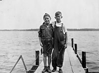 Gerald R. Ford, Jr. and his cousin Gardner James display the day's catch from a dock, Delavan Lake, WI.  1923