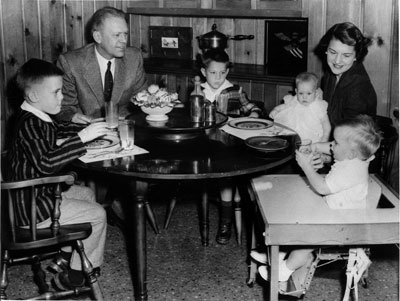 Gerald R. Ford, Jr., Betty Ford, and their children Mike, Jack, Susan, and Steve sit in the dining room of the Ford residence at 514 Crown View Drive, Alexandria, Virginia. 