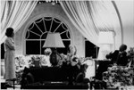 A4232-34A. The President makes a late night telephone call in the second floor residence at the White House as the First Lady watches. 