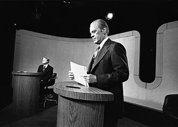 President Ford checks his notes as Jimmy Carter responds during the debate