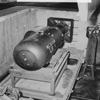 LB (Little Boy) unit on trailer cradle in pit. [Note bomb bay door in upper right-hand corner.], 08/1945 