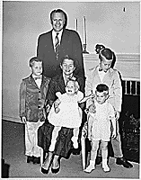 H0006-4. The Ford family poses in front of the fireplace at 514 Crown View Drive, Alexandria, VA. 1959. 