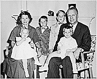 H0007-1. The Ford family poses in front of the fireplace at 514 Crown View Drive, Alexandria, VA. 1959