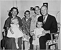 H0007-2. The Ford family poses in front of the fireplace at 514 Crown View Drive, Alexandria, VA. 1959.