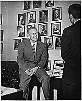 H0011-3. Representative Gerald R. Ford, Jr., talks to an unidentified visitor in his House Office. 1950.