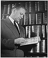 H0012-2. Representative Gerald R. Ford, Jr., pages through a bound copy of 1952 Congressional hearings. 1953.
