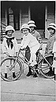 H0021-1. Gerald R. Ford, Jr. (then known as Leslie Lynch King, Jr.) seated on a bicycle, poses with his cousin Gardner James and two unidentified girls. 