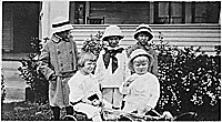 H0028-2. Gerald R. Ford, Jr. (then known as Leslie Lynch King, Jr.) is held by an unidentified woman while his cousins Gardner and Adele James and an unidentified girl flank them. 1913.