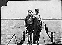 Gerald R. Ford, Jr. and his cousin Gardner James display the day's catch from a dock, Delavan Lake, WI. 1923