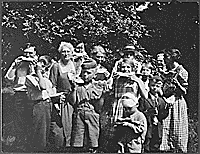 H0030-1. Gerald R. Ford, Jr., his half-brother Tom Ford and cousins Gardner and Adele James, and many other relatives enjoy some watermelon. 1922.