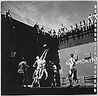 H0060-3. Gerald R. Ford, Jr. fights for the tip-off during a basketball game on the forward elevator of the USS MONTEREY. As physical education director it was Mr. Ford's idea to create a basketball court on the elevator. 1944. 