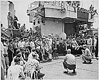H0061-1. Gerald R. Ford, Jr. and members of the crew of the USS MONTEREY watch the festivities as the ship crosses the equator and other crew members pay homage to King Neptune. 1944.