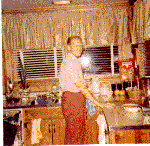 H0072-9. Gerald R. Ford tackles the clean up chores in the kitchen of the family residence at 514 Crown View Drive, Alexandria, VA. 1972.
