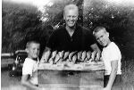 H0073. Gerald R. Ford and sons Jack and Mike show off the days catch following a fishing expedition. 1962.
