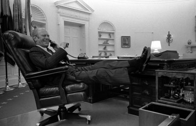 President Ford takes a call after delivering his Address on the Economy to a Joint Session of Congress.  Oval Office.  October 8, 1974.  