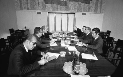 A meeting on the second day of the summit was attended by [l-r] interpreter Mr. Akalovsky,  Secretary of State Henry Kissinger, President Ford, Ambassador Walter Stoessel, Ambassador Anatoly Dobrynin, Foreign Secretary Andrei Gromoyko, Secretary Leonid Brezhnev and his personal interpreter Victor Sukhrodev.  