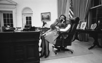 First Lady Betty Ford and daughter Susan share the President's chair in the Oval Office.