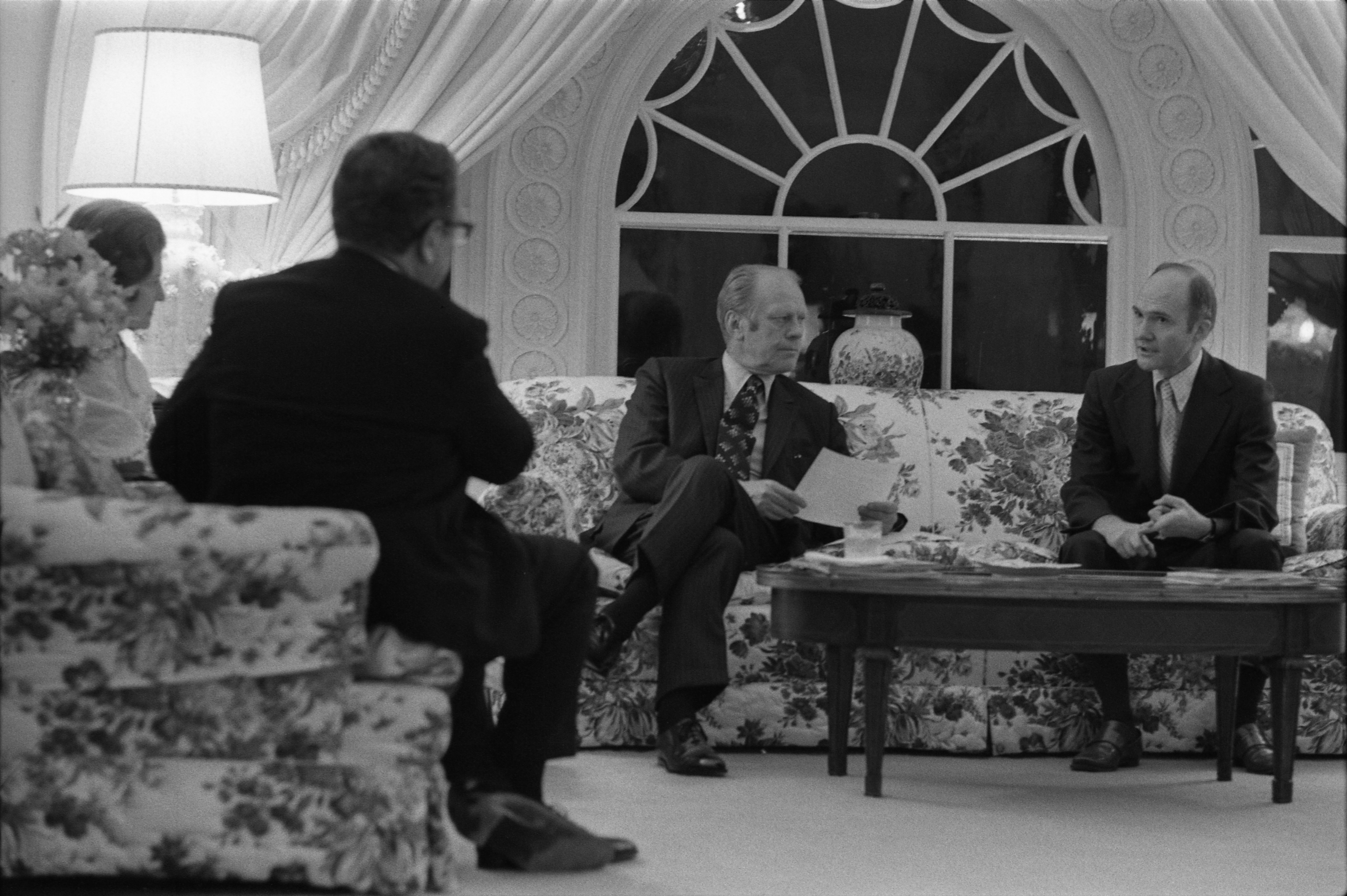 President Ford discusses the evacuation of Saigon with Secretary of State Henry Kissinger and his Deputy Assistant for National Security Affairs Brent Scowcroft during a late night meeting in the White House residence.
