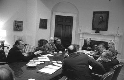 President Ford presides over a National Security Council meeting on the situation on Vietnam.  Roosevelt Room.   April 28, 1975.  (clockwise, l r) William Colby, CIA Director; Robert S. Ingersoll, Deputy Secretary of State; Henry Kissinger, Secretary of State; GRF, James Schlesinger, Defense Secretary;  William Clements, Deputy Secretary of Defense; Vice President Nelson Rockefeller; General George S. Brown, Chairman of the Joint Chiefs of Staff;  Lt. Gen. Brent Scowcroft, Deputy Assistant for National Security Affairs (lower left corner).  