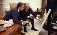 President Ford and the Shah of Iran, Mohammad Reza Pahlavi, look at charts related to the USS Mayaguez military operation earlier that month, during the State Visit of the Shah and Shahbanou, Farah Pahlavi.  May 15, 1975.  