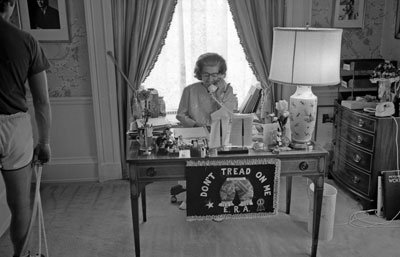 First Lady Betty Ford works at her desk in the East Wing, where a “Don’t Tread on Me” ERA doormat hangs.  June 30, 1975.  