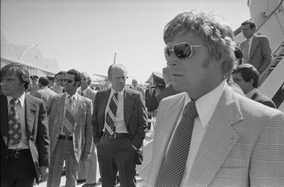 Upon arriving at McClellan Air Force Base after the attempt on his life by Lynette “Squeaky”  Fromme, President Ford waits to board Air Force One and return to Washington.  Also shown are Secret Service agents and Chief of Staff Don Rumsfeld (descending ramp of plane).  