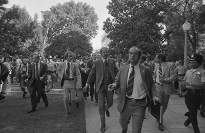 Secret Service agents rush President Ford towards the California State Capitol following the attempt on the President's life by Lynette "Squeaky" Fromme, in Sacramento, California.  