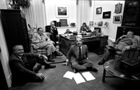 President Ford and staff watch a replay of his address to the Nation on recommendations for tax reduction and spending, televised earlier that evening. 