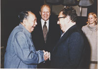 President Ford and daughter Susan watch as Secretary of State Henry Kissinger shakes hands with Mao Tse-Tung; Chairman of Chinese Communist Party, during a visit to the Chairman’s residence. December 2, 1975 